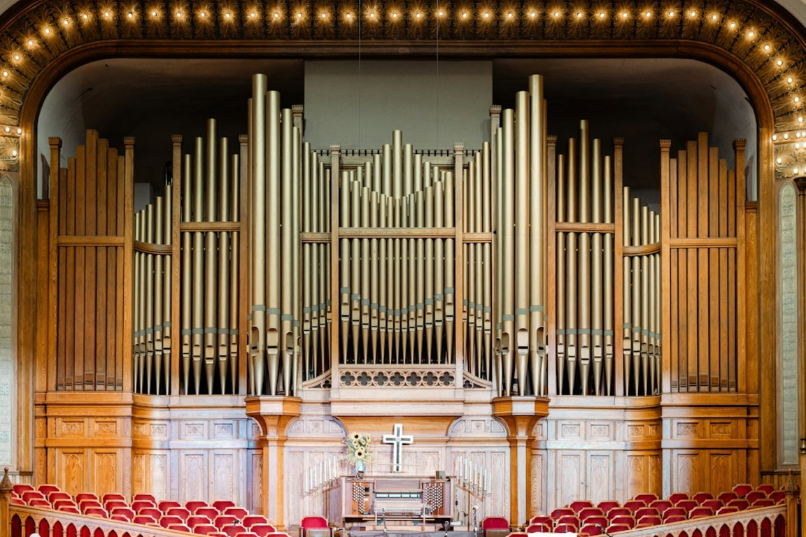 a-large-pipe-organ-in-a-church-with-red-seats.jpg a large pipe organ in a church with red seats